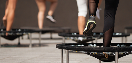 Fitness women jumping on small trampolines,exercise on rebounderの写真素材