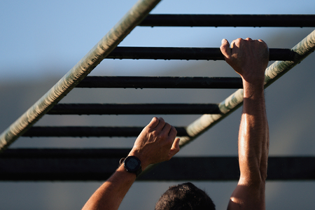 Mud race running over obstacles race runners,hands overcome obstacle.Hand over handの写真素材