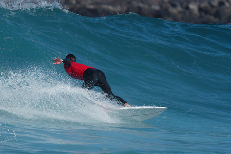 Sports man surfing wave on surfboard in oceanの写真素材