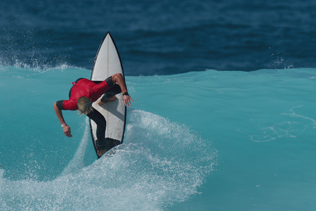 Sports man surfing wave on surfboard in ocean