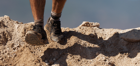 Trail running action close up of running shoes in action