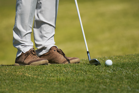Playing golf preparing to shot,man putting on green
