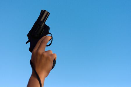 A hand shotting a gun for starting raceの写真素材