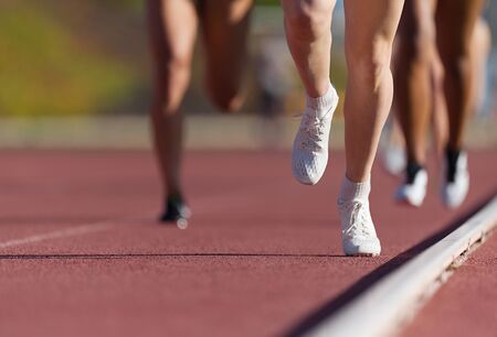 Group of athletes sprinters run speed on track of stadiumの写真素材