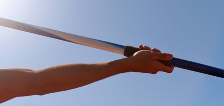 Athlete about to throw a javelin in the stadiumの写真素材