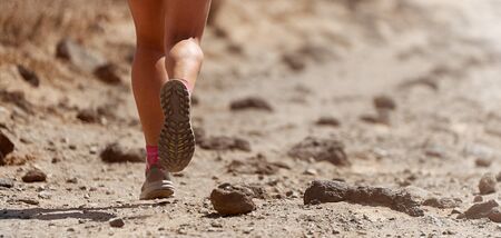 Trail running action close up of running shoes in action