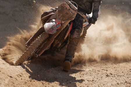 Motocross racer accelerating speed in track,driving in the motocross raceの写真素材