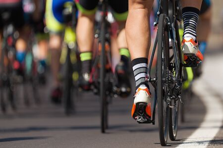 Cycling competition cyclist athletes riding a race at high speed, detail of cycling shoes