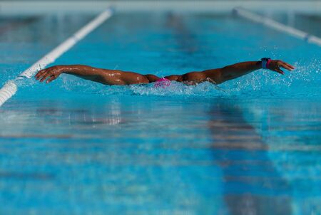 Swim competition swimmer athlete doing butterfly stroke in swimming poolの写真素材