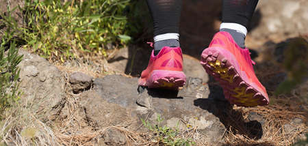 Trail running woman on mountain path exercising