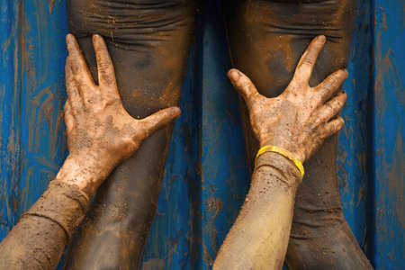 Mud race runners assistance for breakthrough, help in overcoming obstaclesの写真素材