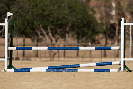 Wooden barriers for jumping horses, empty field for horse jumping event competitionの写真素材