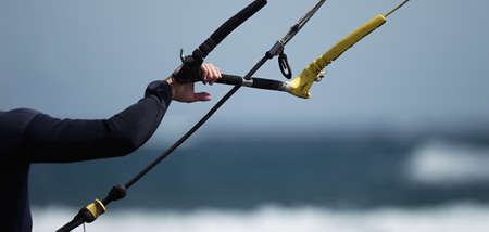 Man kitesurfer ready for kite surfing rides in blue seaの写真素材