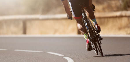Road bike cyclist man cycling, athlete on a race cycleの写真素材