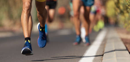 Marathon running race, people feet on city roadの写真素材