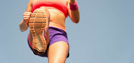 Woman running marathon detail of sole of sport shoes