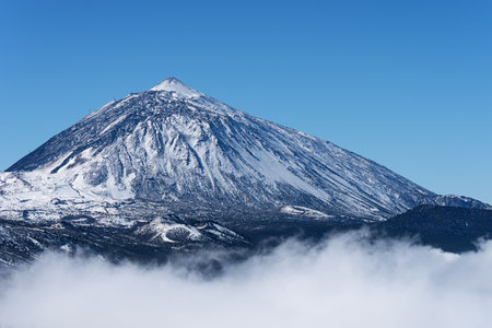 Pico del Teide mountain volcano in snow, bright blue sky. Teide National Park, Tenerife, Canary Islands, Spainの写真素材