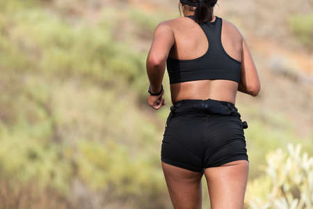 Trail running woman on mountain path exercisingの写真素材