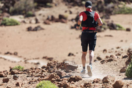 Male athlete run mountain race wth hydratation trail vest for runningの写真素材