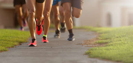 Marathon running race, athletes running on city sidewalkの写真素材