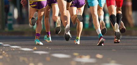 Marathon runners running on city road, large group of runnersの写真素材