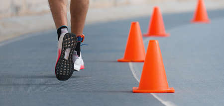 Runner feet running on stadium closeup, running on a blue racetrackの写真素材