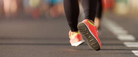 Running shoe closeup of woman running on road with sports shoes