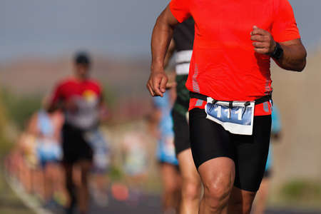 Marathon man running on the asphalt roadの写真素材
