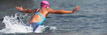 Swimmer at the start, jump flight into the oceanの写真素材