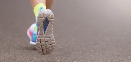 Athlete runner feet running on road close up on shoe, marathon running race