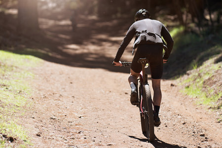 Mountain biking man riding on bike in summer mountains forest landscape