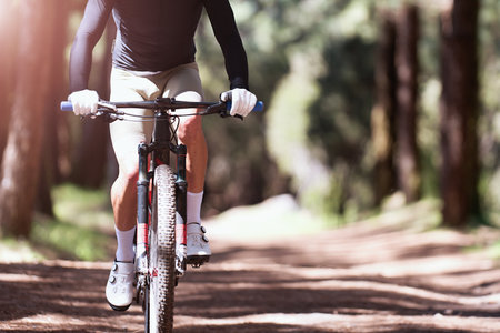 Mountain biking man riding on bike in summer mountains forest landscapeの写真素材