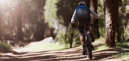 Mountain biking man riding on bike in summer mountains forest landscapeの写真素材