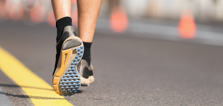 Athlete runner, feet running on road close up on shoe, marathon running raceの写真素材
