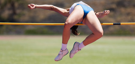 High jump athletics, high jump female athlete successful attempt over barの写真素材