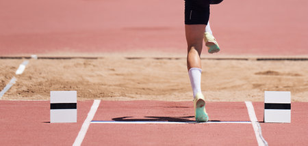 Long jump men athlete jump in athletics competition, sportsman landing his leg on board before taking off in long jump or triple jumpの写真素材