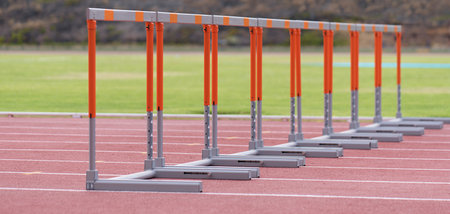 Eight track hurdles on a track in each laneの写真素材