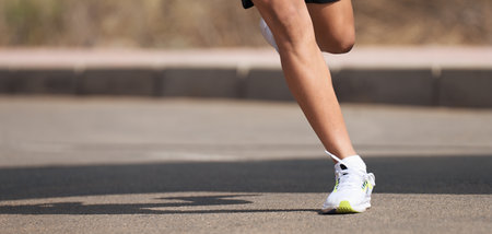 Running children, young athlete run in a kids run race, running on city road, detail of running shoesの写真素材