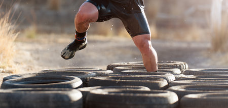 Mud race runners, tries to make it through the tire trap