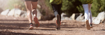 Running children, young athletes run in a kids run race, running on forest road detail on legs, running in the light of morningの写真素材
