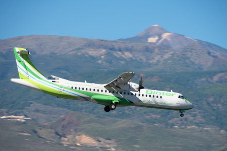 Tenerife, Spain December 9th, 2023. ATR 72-600 Binter Canarias Airlines flies in the blue sky. Landing at Tenerife Airport. El Teide volcano in the backgroundのeditorial素材