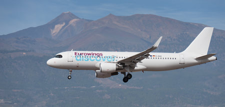 Tenerife, Spain January 13th, 2024. Airbus A320-214 Discover Airlines flies in the blue sky. Landing at Tenerife Airport. El Teide volcano in the backgroundのeditorial素材