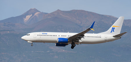 Tenerife, Spain January 13th, 2024. Boeing 737-8K5 Jettime Airlines flies in the blue sky. Landing at Tenerife Airport. El Teide volcano in the backgroundのeditorial素材