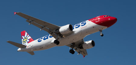 Tenerife, Spain January 31st, 2024. Airbus A320-214 Edelweiss Air Airlines flies in the blue sky. Landing at Tenerife Airportのeditorial素材