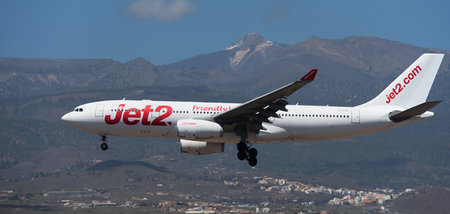 Tenerife, Spain March 30th, 2024. Airbus A330-243 Jet2 Airlines flies in the blue sky. Landing at Tenerife Airport. El Teide volcano in the backgroundのeditorial素材