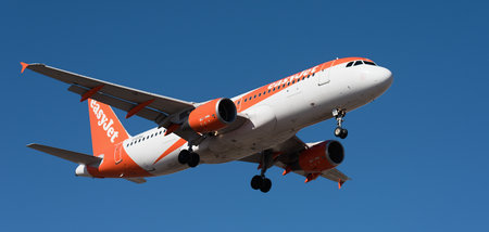 Tenerife, Spain january 9st, 2026. Airbus A320-214 easyJet Airlines flies in the blue sky. Landing...