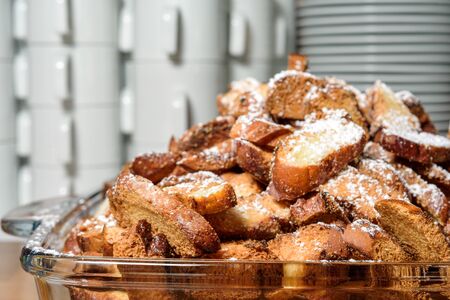 crackers and pretzels on a glass tray on the background of cookware