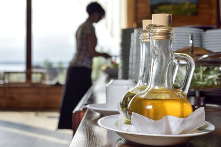 two types of olive oil in carafes on background buffet tableの写真素材