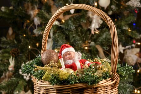 Christmas wicker basket with Christmas gifts under the Christmas treeの写真素材
