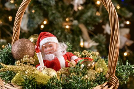 Christmas wicker basket with Christmas gifts under the Christmas treeの写真素材